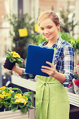 Image showing happy woman with tablet pc in greenhouse