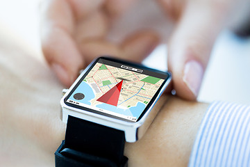 Image showing close up of hands with map on smartwatch screen