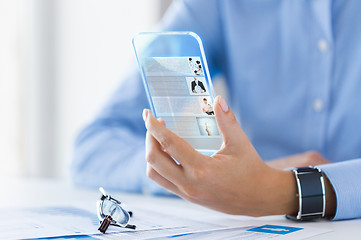 Image showing close up of woman with transparent smartphone