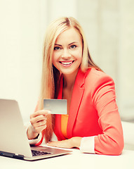 Image showing businesswoman with laptop using credit card