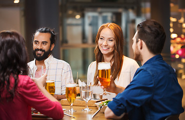 Image showing friends dining and drinking beer at restaurant