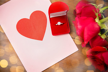 Image showing close up of diamond ring, roses and greeting card