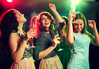 Image showing smiling friends with glasses of champagne in club