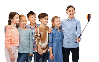 Image showing happy children with smartphone and selfie stick