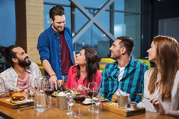 Image showing friends dining and drinking wine at restaurant