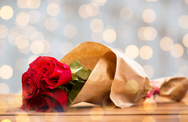 Image showing close up of red roses bunch wrapped into paper