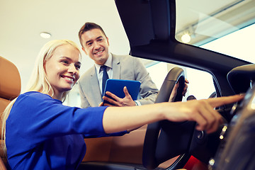 Image showing happy woman with car dealer in auto show or salon