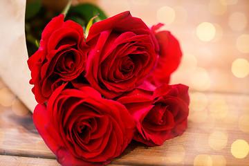 Image showing close up of red roses bunch wrapped into paper