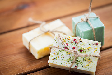 Image showing close up of handmade soap bars on wood