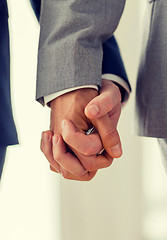 Image showing close up of male gay couple holding hands