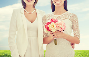 Image showing close up of happy lesbian couple with flowers