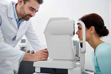 Image showing optician with tonometer and patient at eye clinic