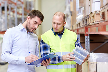Image showing worker and businessmen with clipboard at warehouse