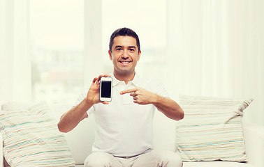 Image showing happy man with smartphone at home