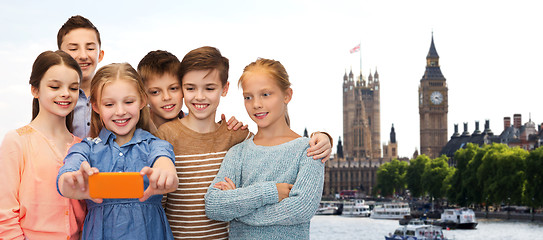 Image showing happy children talking selfie by smartphone