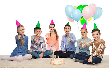 Image showing happy children in party hats with birthday cake