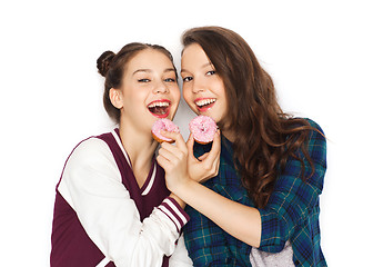 Image showing happy pretty teenage girls eating donuts