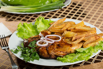 Image showing Tobacco chickens with fried potatoes. 