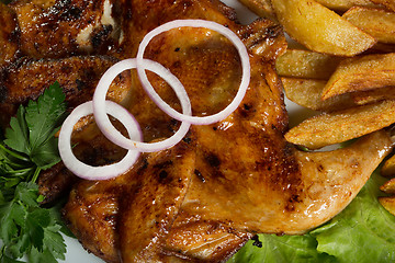 Image showing Tobacco chickens with fried potatoes. 