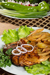 Image showing Tobacco chickens with fried potatoes. 