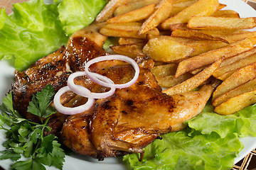 Image showing Tobacco chickens with fried potatoes. 