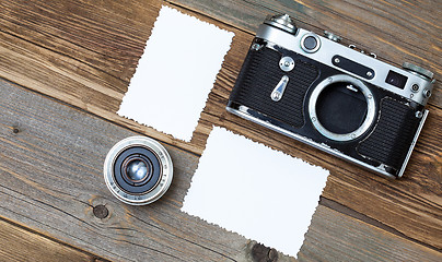 Image showing retro photo mock up, vintage camera and lens on old wooden backg