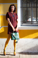 Image showing pretty middle-aged woman with a green handbag