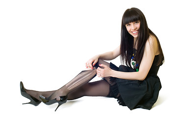 Image showing Young smiling woman in torn stockings