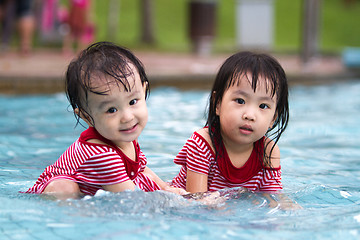 Image showing Two Little Sisters Playing in Water