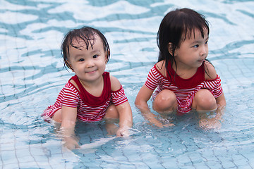 Image showing Two Little Sisters Playing in Water