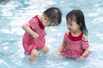 Image showing Two Little Sisters Playing in Water