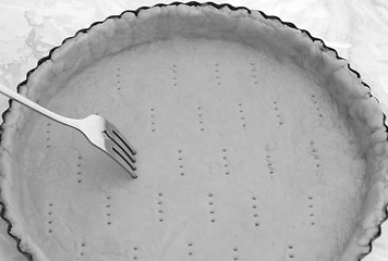 Image showing Fork making holes in a raw pastry case