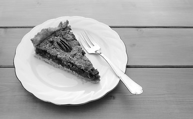 Image showing Slice of pecan pie on a china plate with a fork