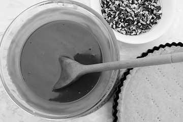 Image showing Making pecan pie - stirring the filling with a wooden spoon