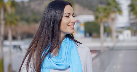 Image showing Smiling vivacious young woman in an urban street