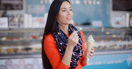 Image showing Attractive stylish young woman in a delicatessen