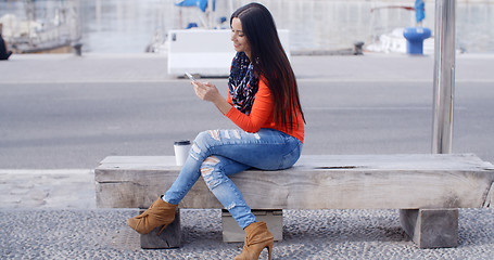 Image showing Relaxed confident young woman on a mobile