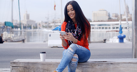 Image showing Relaxed confident young woman on a mobile