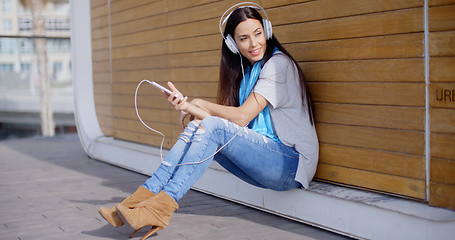 Image showing Pretty trendy young woman enjoying her music