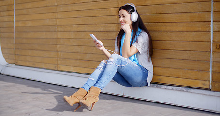 Image showing Attractive young woman listening to her music