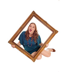 Image showing Woman sitting on floor with picture frame.