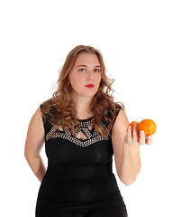 Image showing Blond woman holding two oranges.