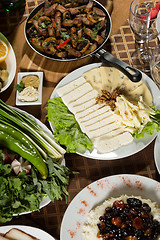 Image showing table with normal food, steaks and potatoes. 