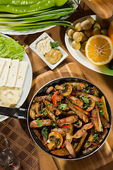 Image showing table with normal food, steaks and potatoes. 