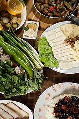 Image showing table with normal food, steaks and potatoes. 