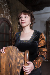 Image showing Pretty woman an armchair and with wine glass