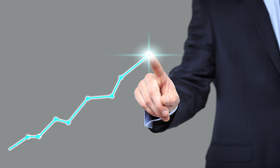 Image showing Businessman Touching a Graph Indicating Growth