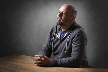 Image showing Man sitting on table