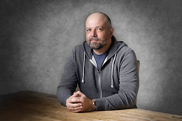 Image showing Man sitting on table