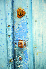 Image showing   metal     nail dirty stripped paint in the blue woo  knocker